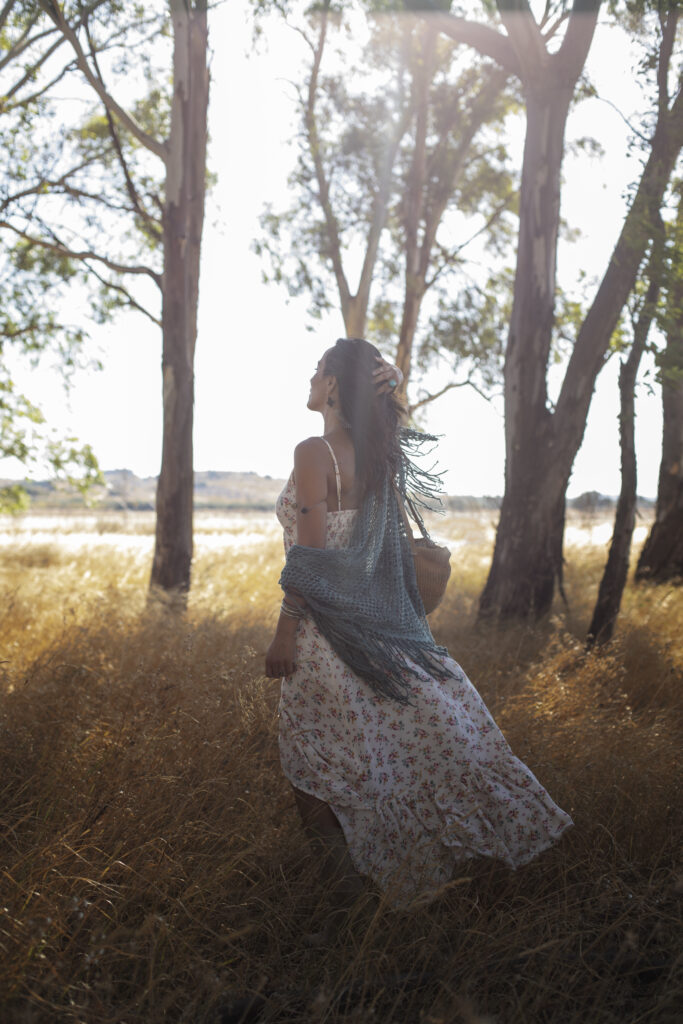 A woman in serene forest path representing nature as a teacher and guide for life lessons